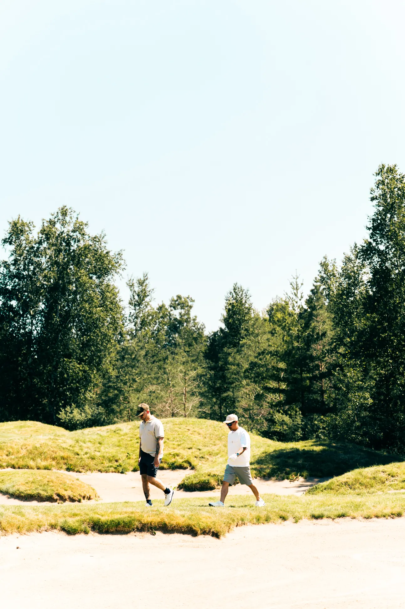 Two golfers walking between bunkers at FireRock